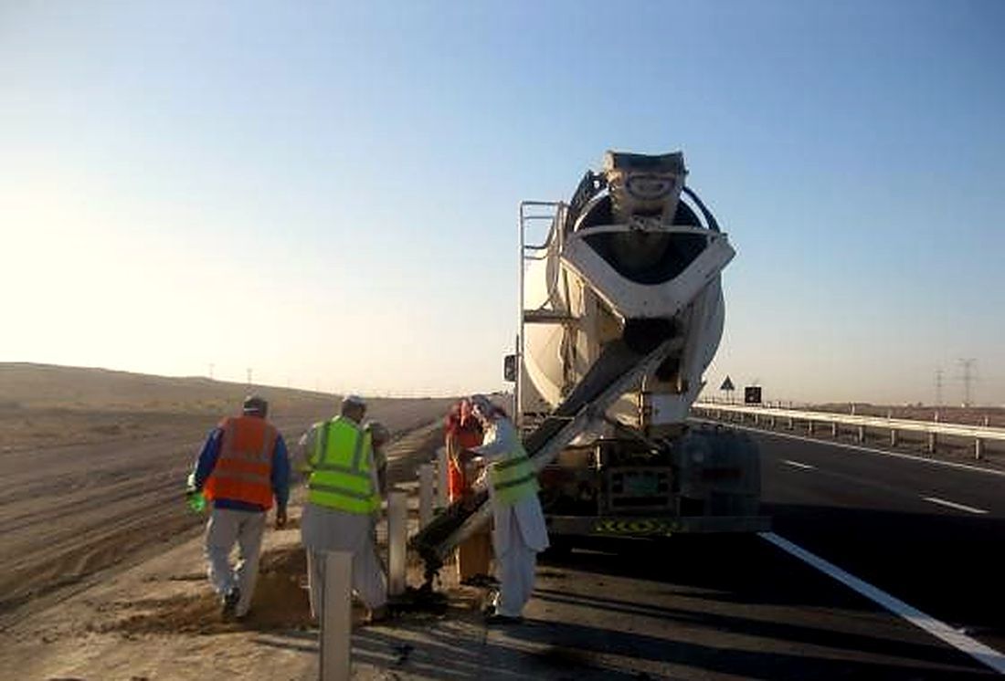 Concrete pour from a mixer truck on a highway project